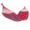 A red, purple, and green striped Aruba Cayenne Hammock, with wooden spreader bars, fully extended.